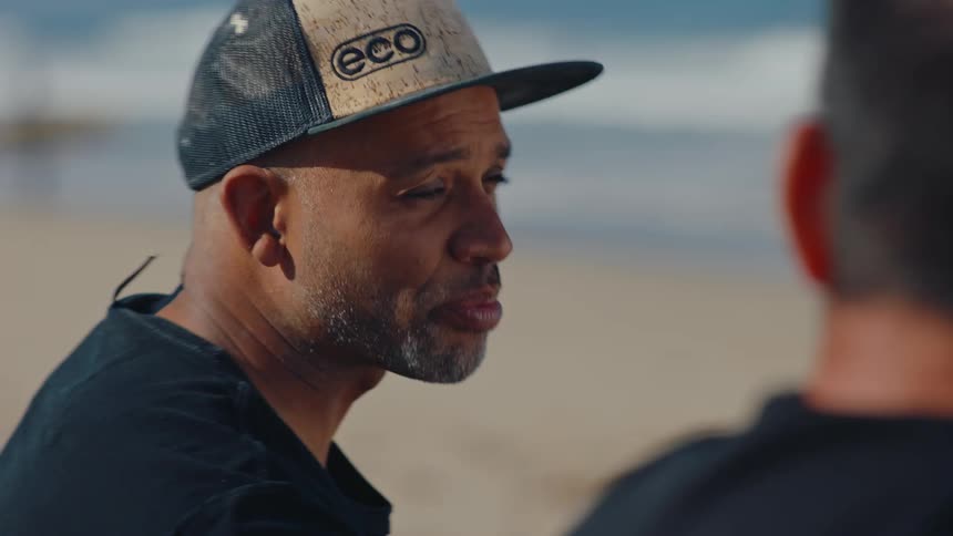 Two men talking on the beach