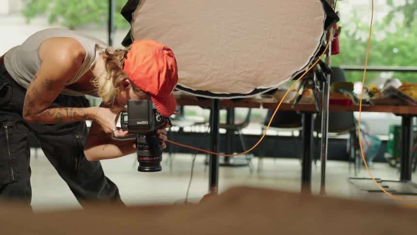 A woman is taking pictures in a restaurant