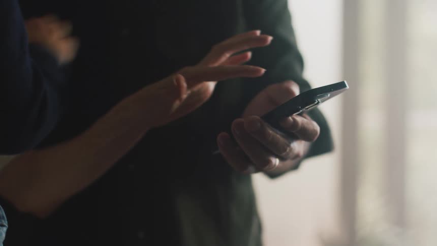 Three people clicking on a smartphone