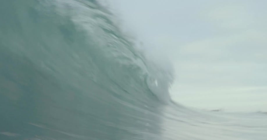 A large wave crashes in the ocean