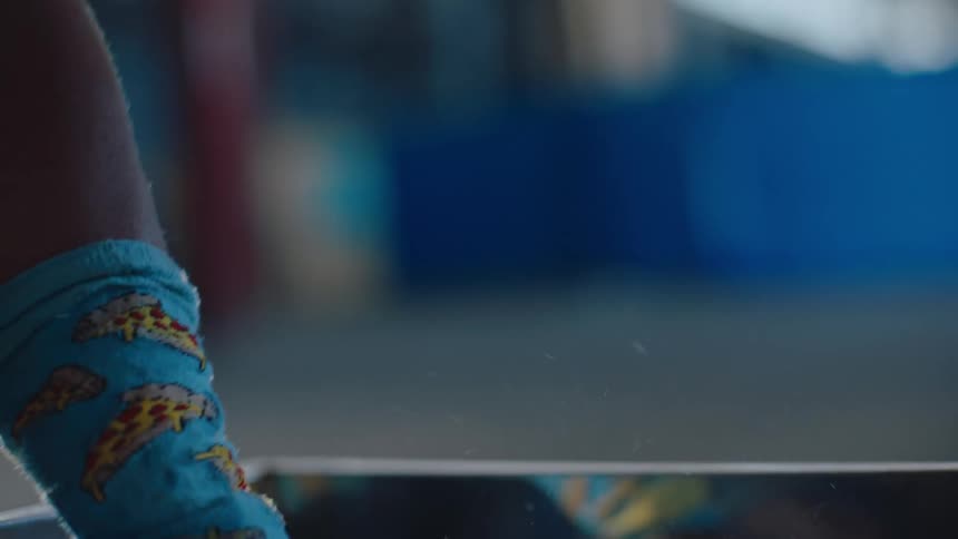 A person with a blue wristband on his wrist and his hand is picking up several microplasts from a metal drawer