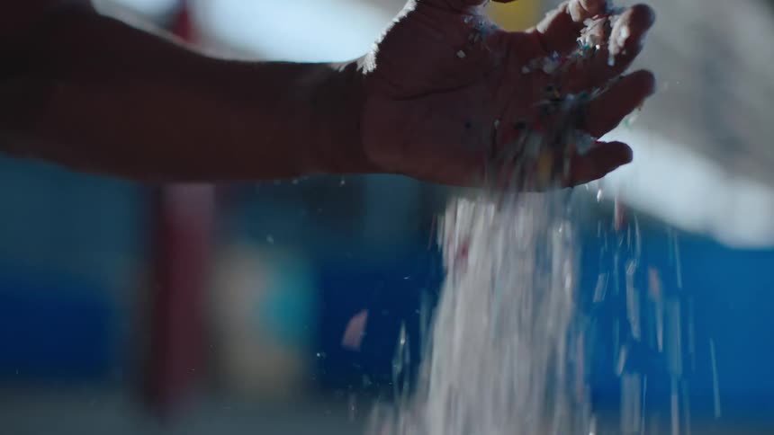 Hand picking up and dumping recyclable plastic