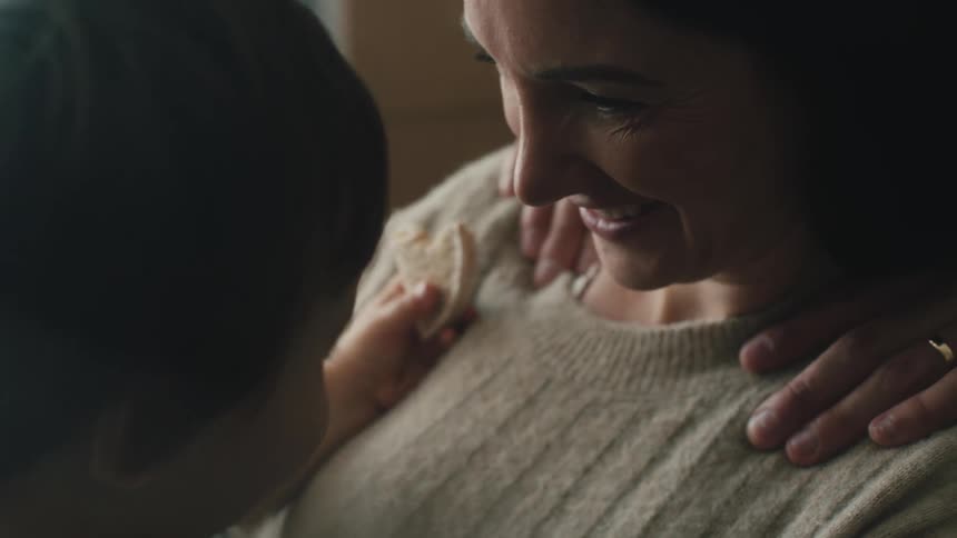 A mother is holding her son