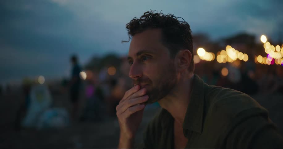 A man is sitting on the beach