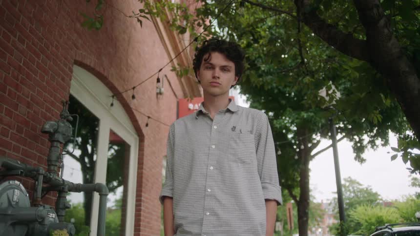 A man is standing by the building