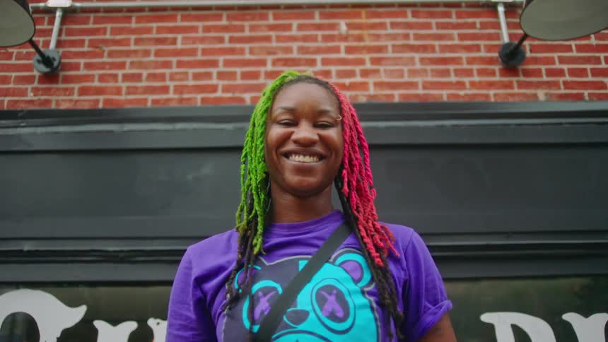 Portraits of a woman smiling and with colorful hair