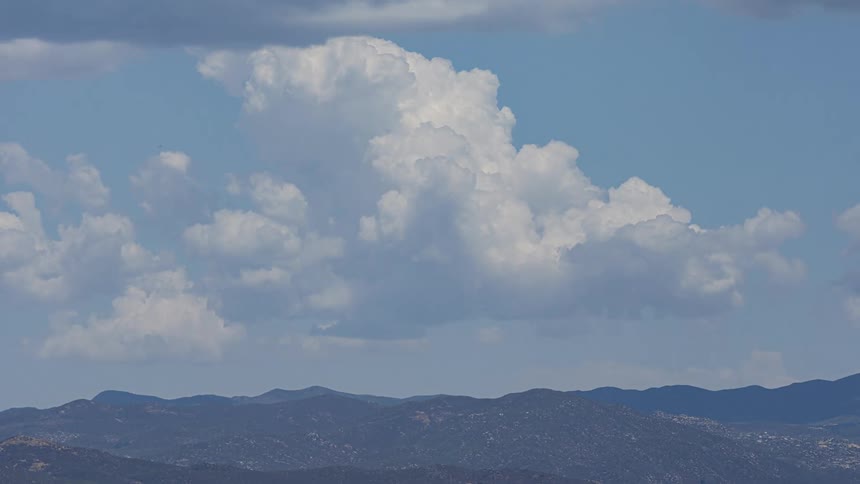 Clouds above mountains during daytime
