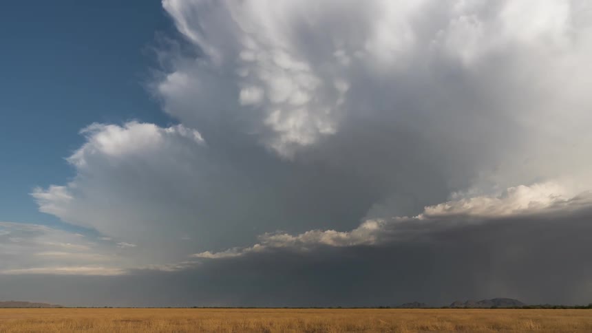 Scene of a vast field with a nebula storm approaching