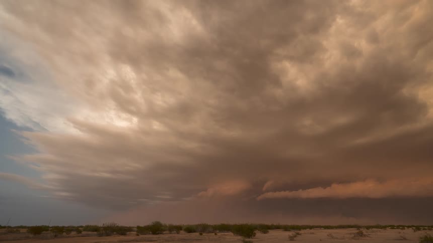Storm clouds develop over a desert