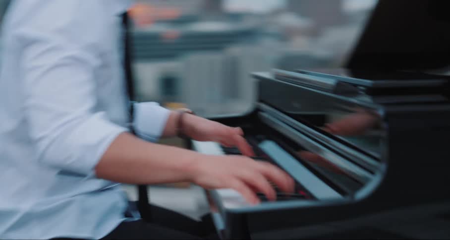 Man playing piano on the terrace of a building