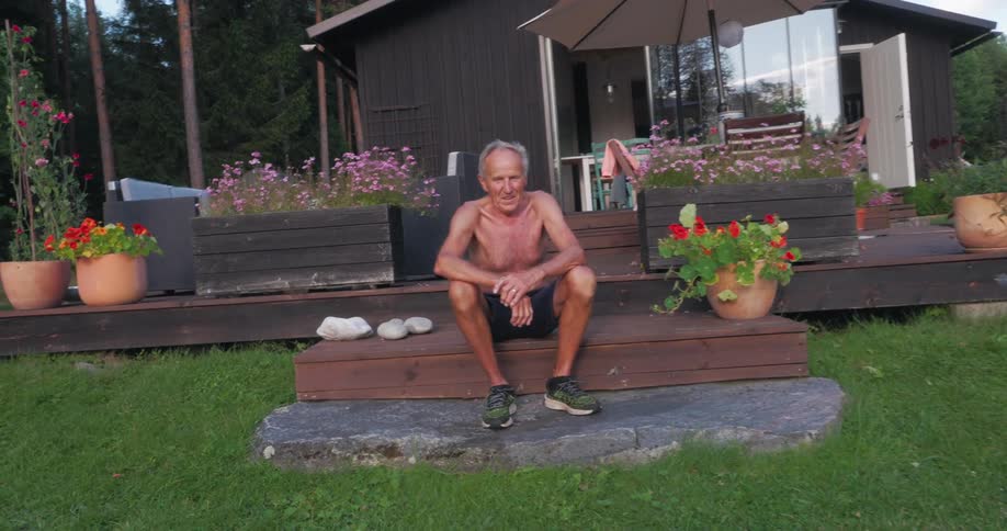 Portrait of a man smiling while sitting on wooden steps