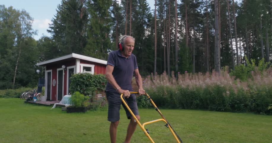 A man is mowing the grass