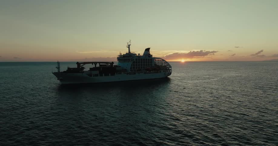 Large ship at sea during sunrise