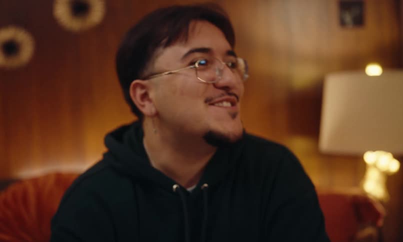 Man sitting on a dandelion with candles talking happily