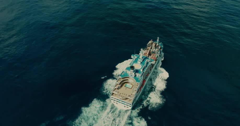 Ship in cruise mode and transporting containers traveling at sea