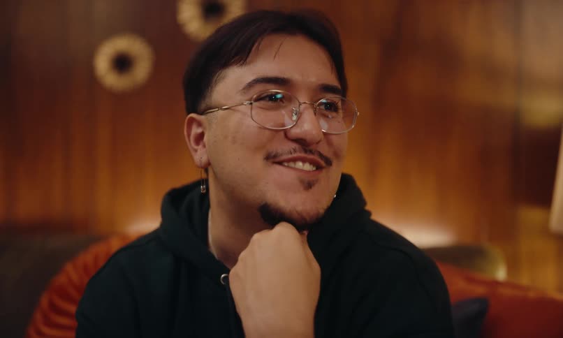 A man is smiling and talking