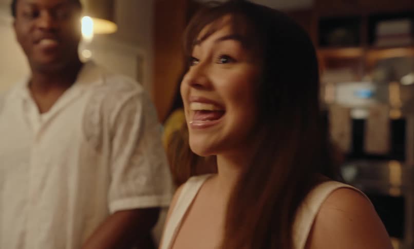 A woman is talking with people at a party