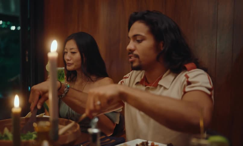Friends sitting at a table with plates of food and drinks