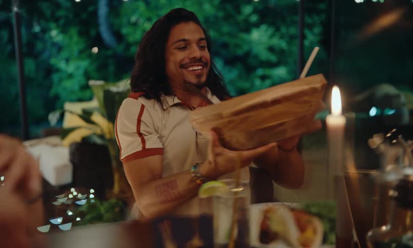 People are passing dishes at the table
