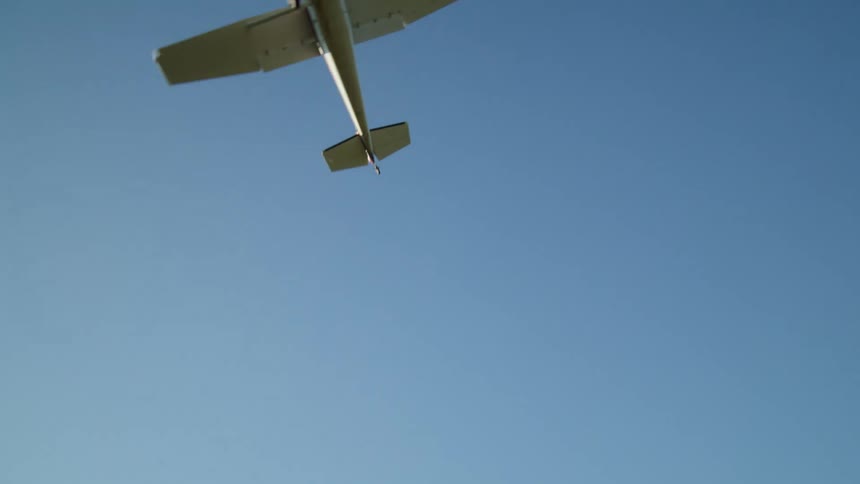Small plane flying over mountains and forests