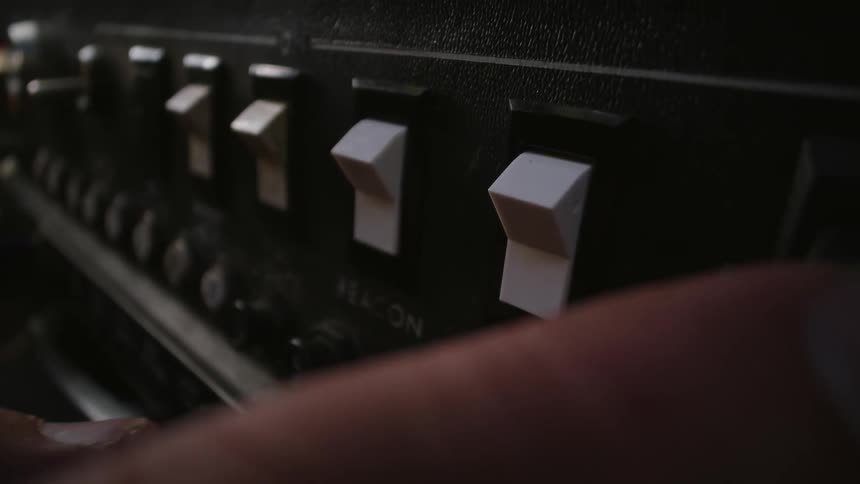 Fingers of a person turning on switches
