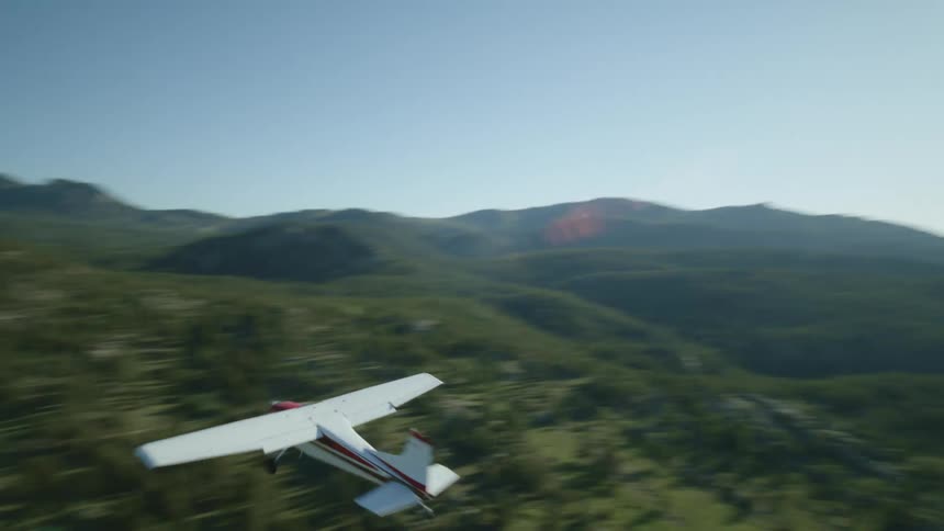 A plane descends on the fields