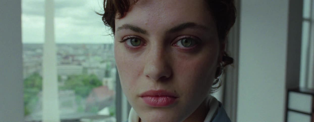 Portrait of a young woman with light eyes and short hair in an indoor setting