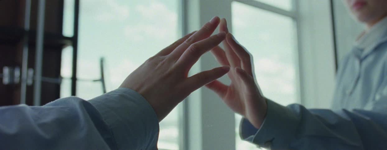 A woman touches the mirror in the bathroom