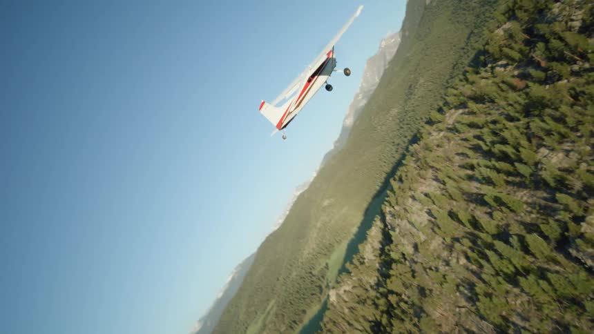 Private single engine plane flying above mountains