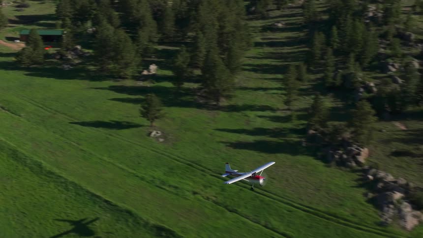 Single engine plane taking off in a mountainous environment during the day