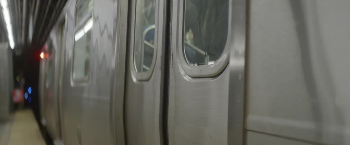 A subway door closes as it prepares to depart