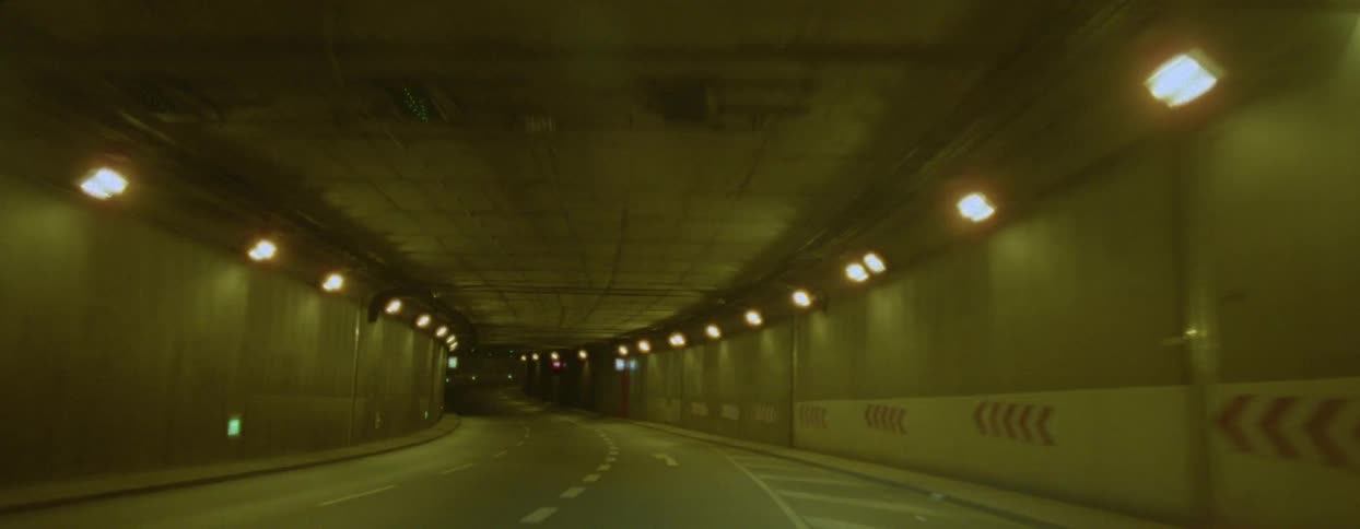 Moving view of a tunnel on a city highway at night