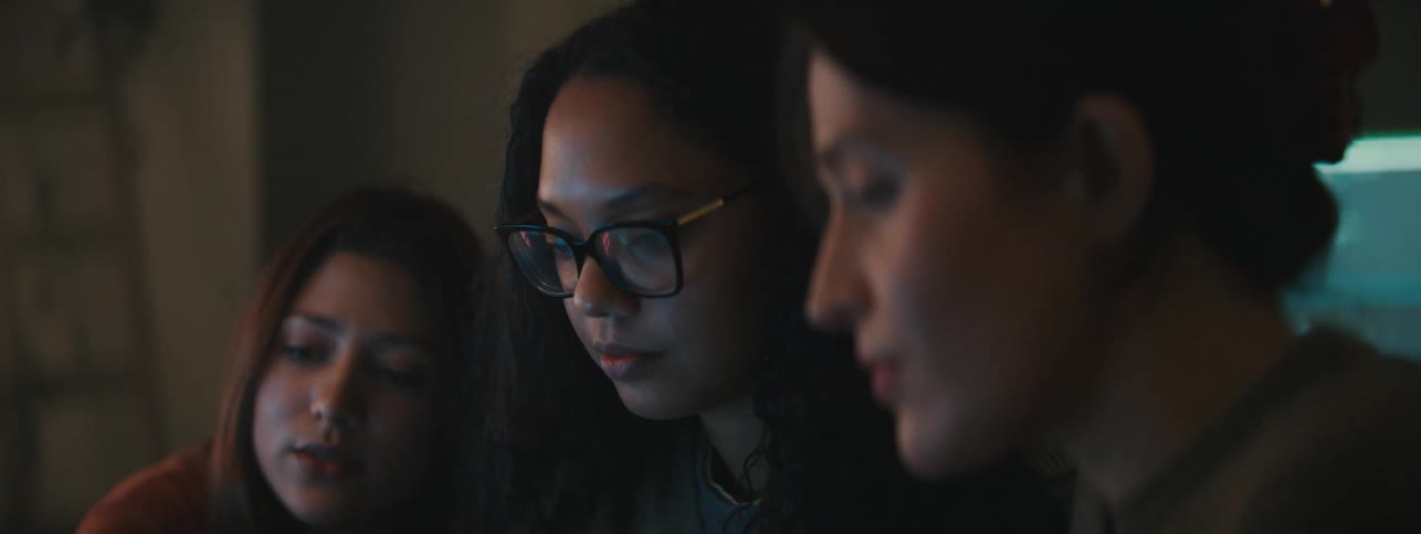 Women talk while looking at a computer