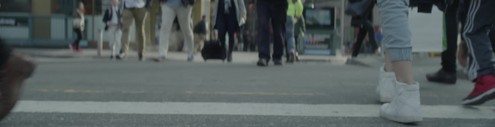 Pedestrians walk through a city street