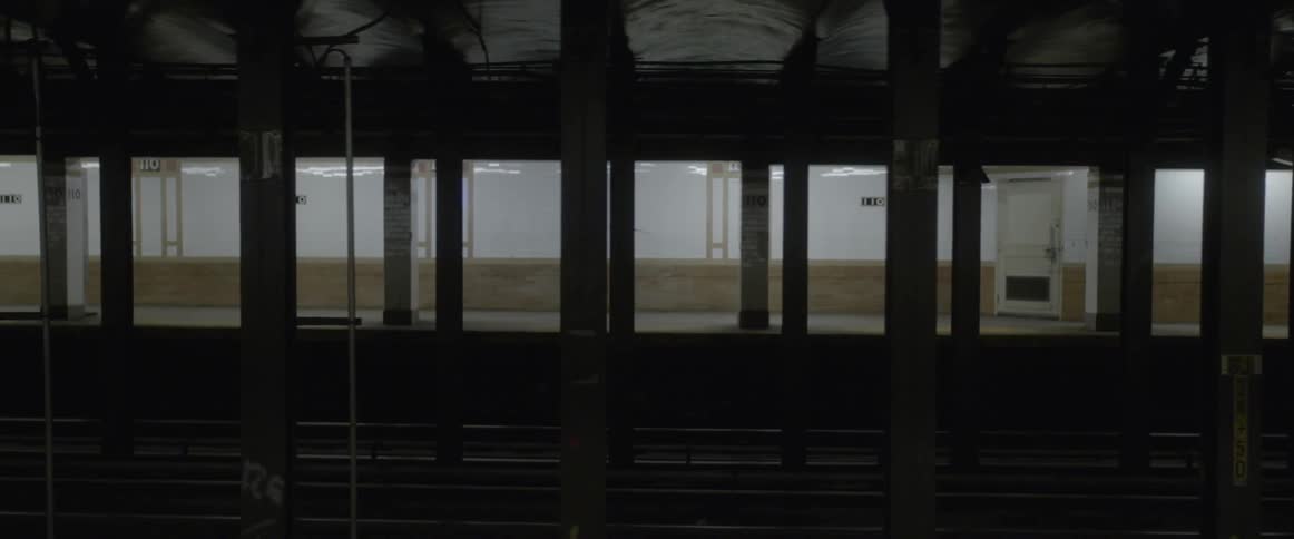 A darkly lit empty subway station