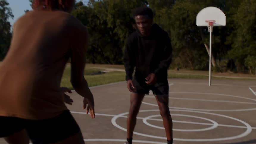 A man runs while dribbling the basketball