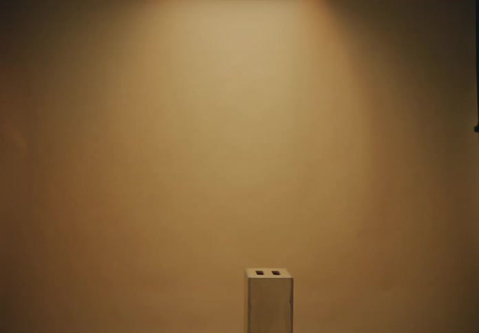 Room with beige wall and a small box with two entrances