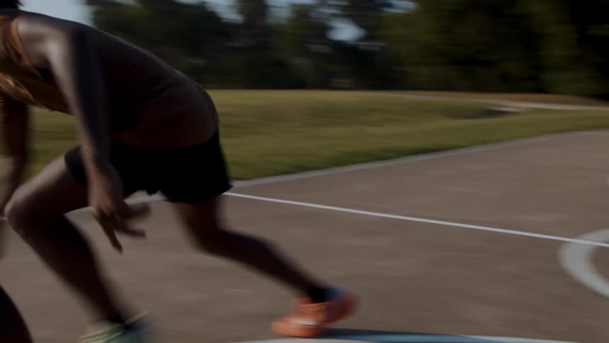 Two men are playing one on one basketball