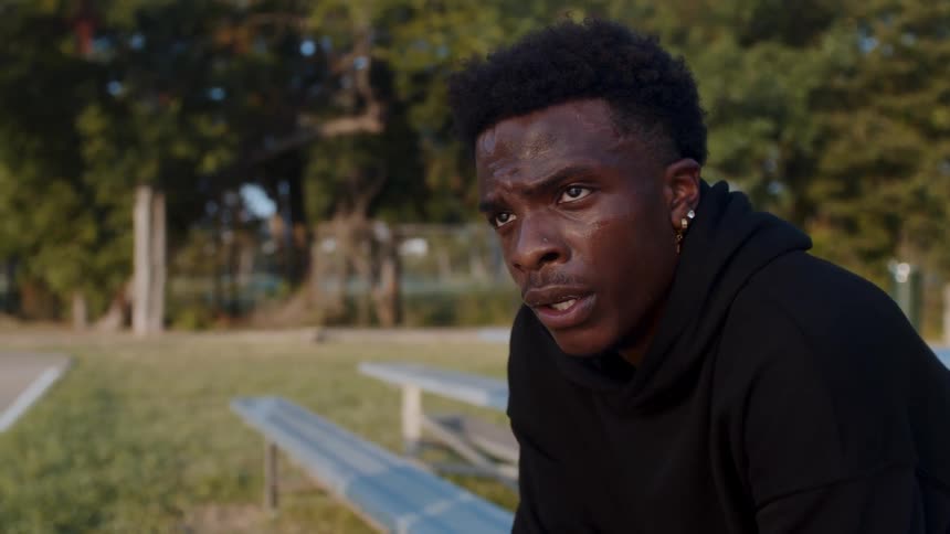 Sweaty man sitting on a bleacher