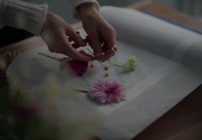 Pair of hands assembling a flower arrangement