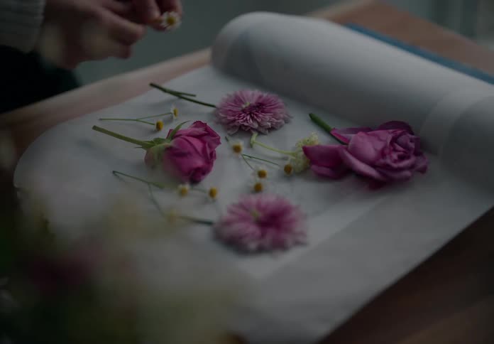 Womans hand assembling a flower composition