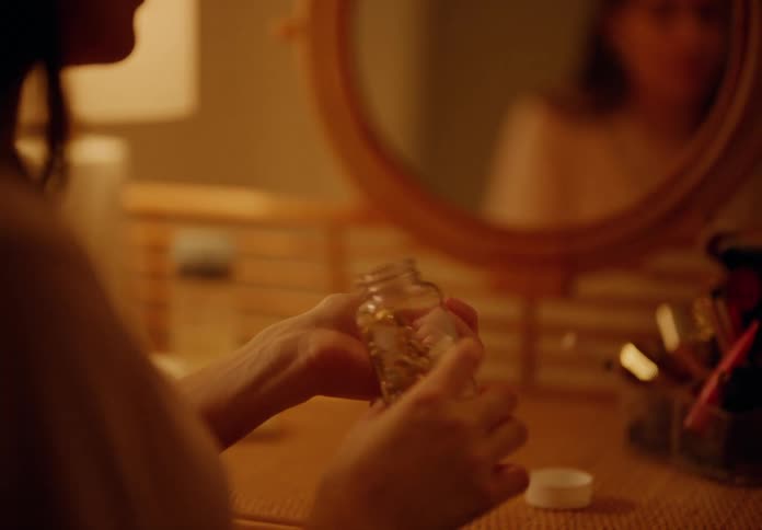 Woman sitting taking capsule