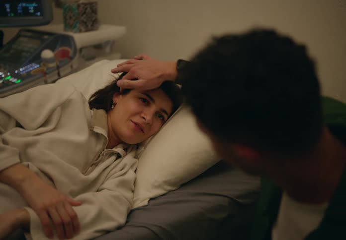 A man accompanies his spouse during an echo sonogram