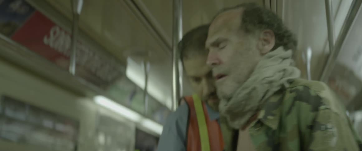A subway worker helps a man get off the train