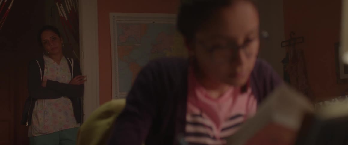 Woman watches her daughter study at her desk