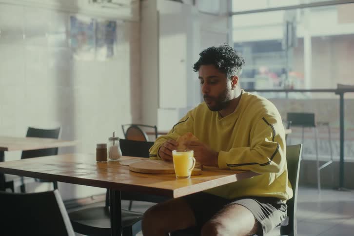 Man eating sandwich in a restaurant