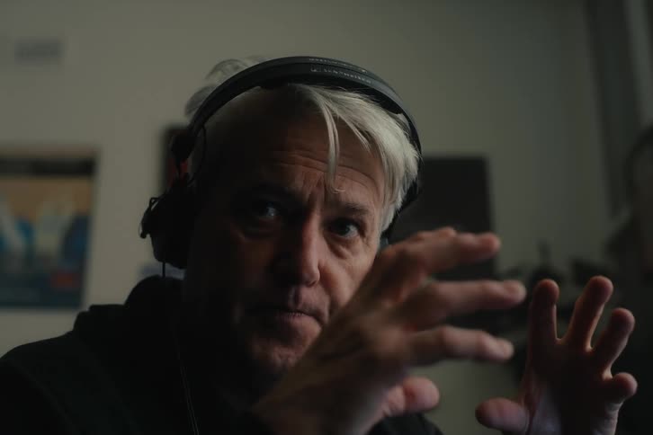Portrait of a man indoors talking and moving his hands