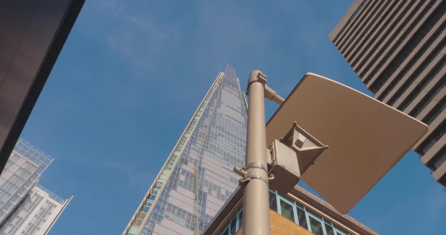 Upward view of buildings with modern architecture against a blue sky