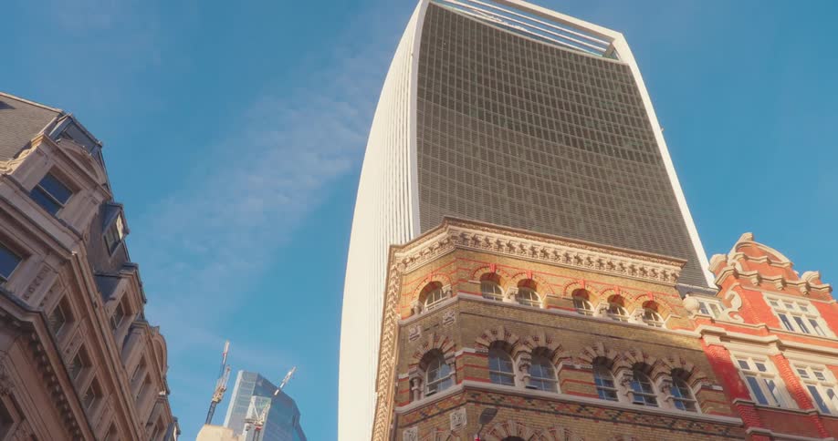 A tall skyscraper is behind the apartment buildings