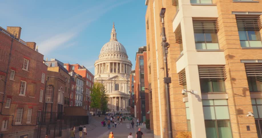 City with modern and rustic buildings with a dome in the background and people walking